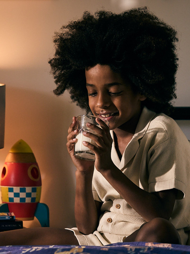 Boy drinking milk in bed