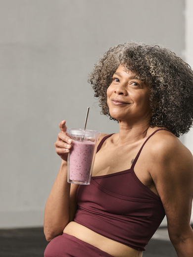 Woman in gym with smoothie