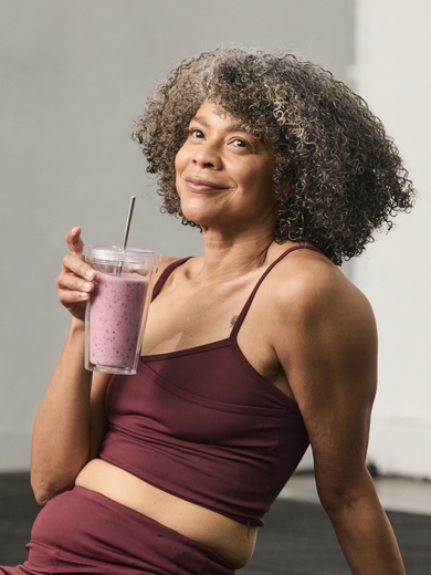 Woman in gym with smoothie