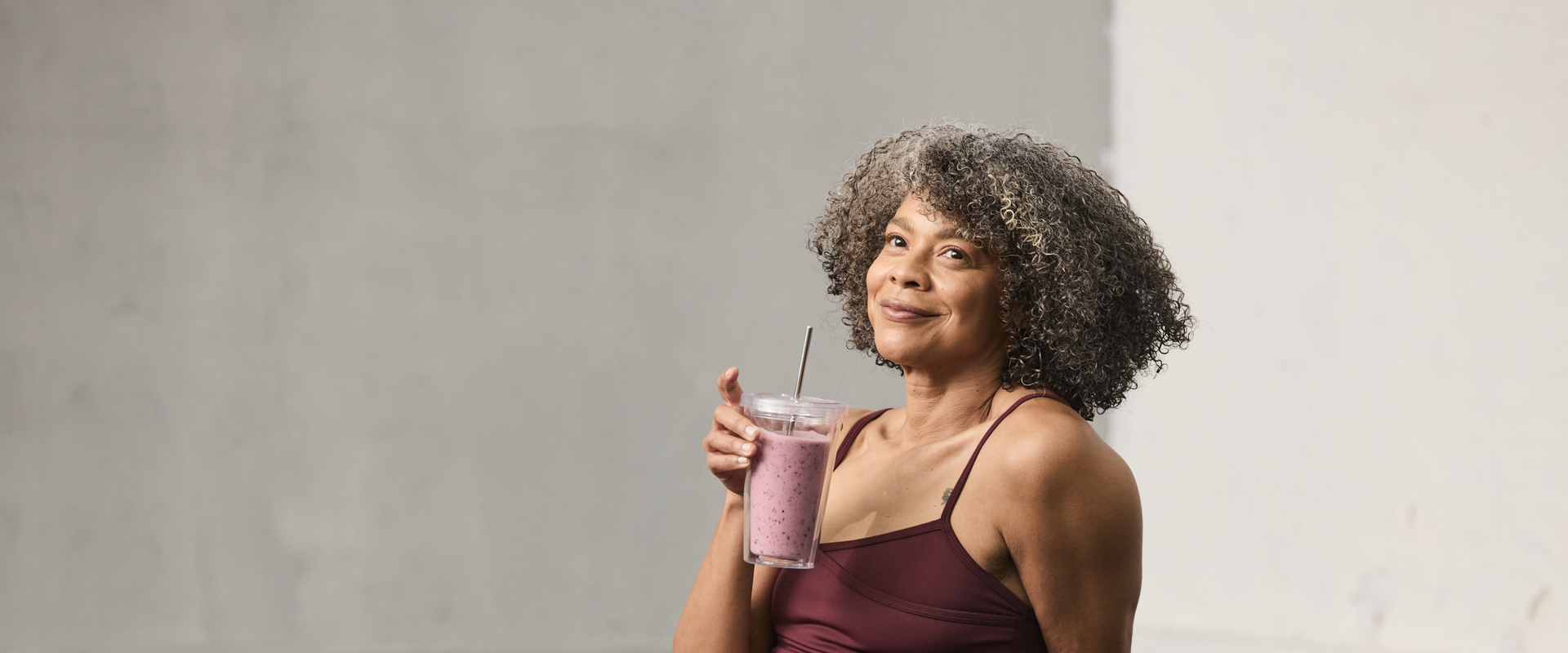 Woman in gym with smoothie