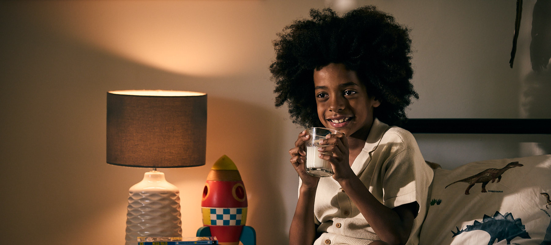 Boy drinking milk in bed