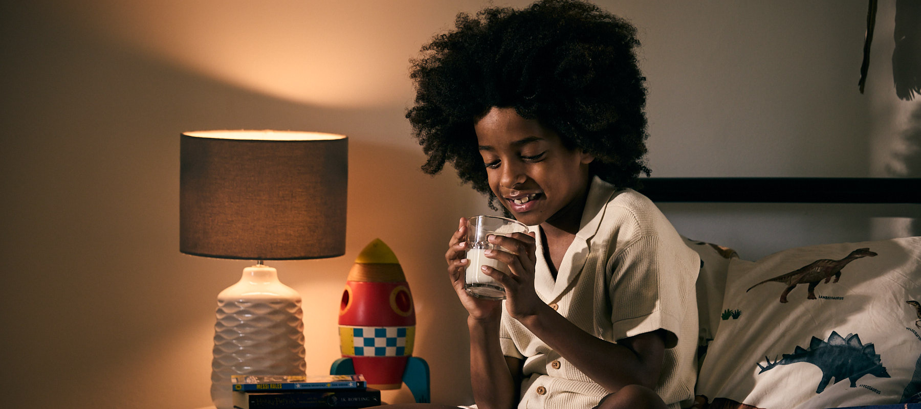 Boy drinking milk in bed
