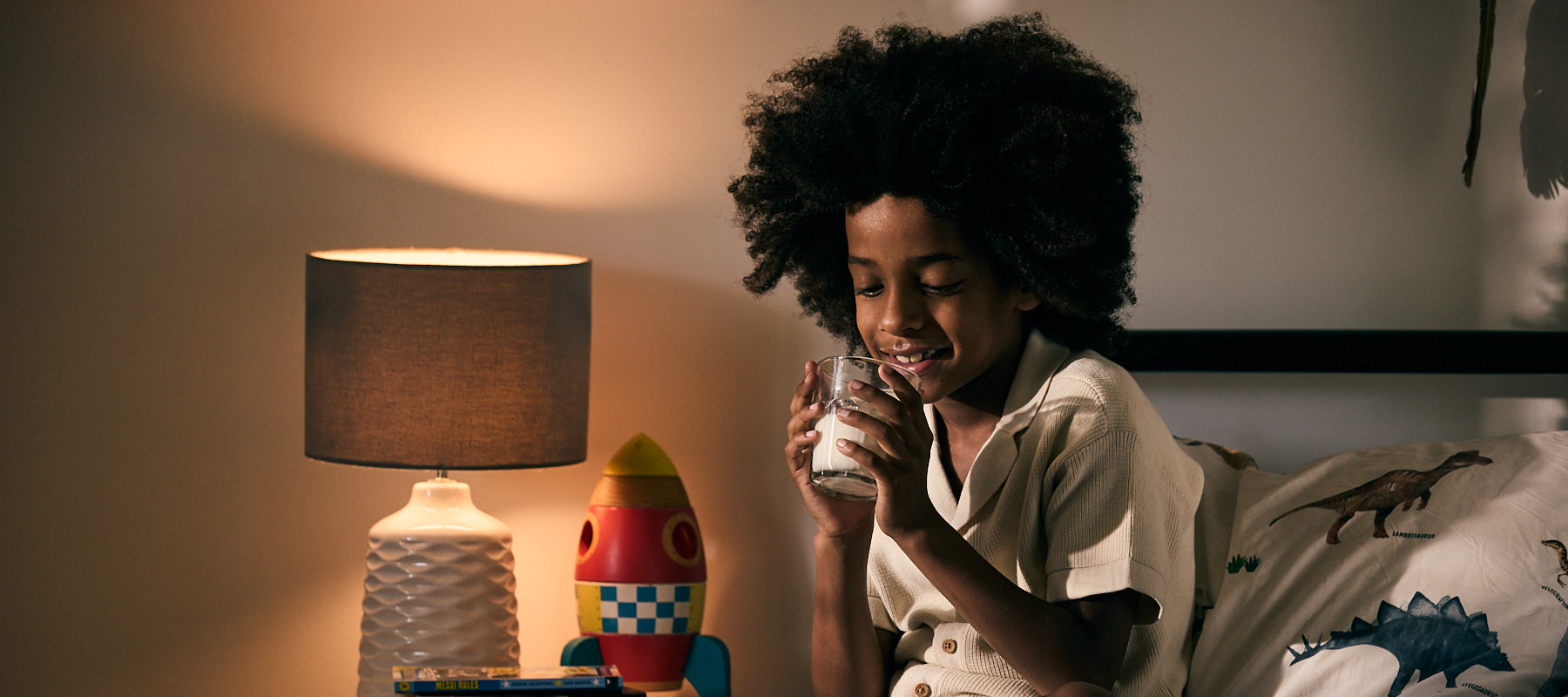 Boy drinking milk in bed