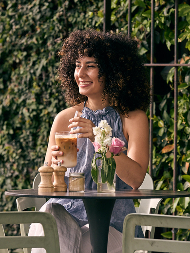 Woman drinking iced latte