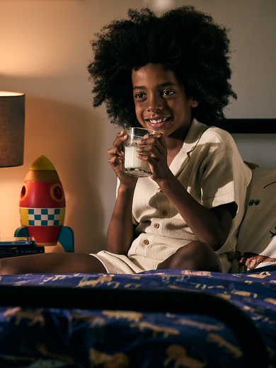 Boy drinking milk in bed