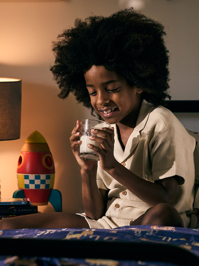 Boy drinking milk in bed