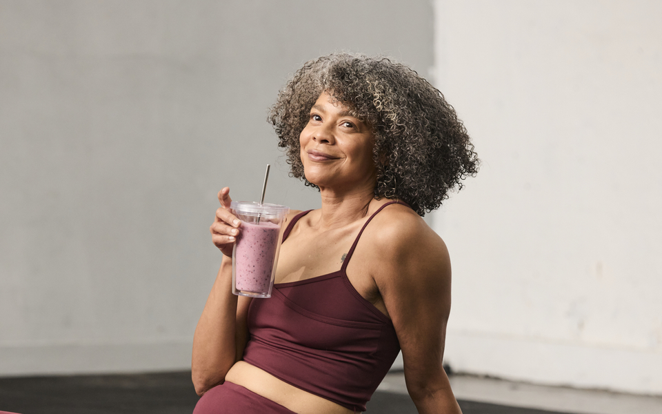 Woman in gym with smoothie